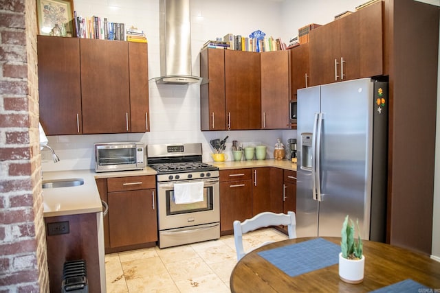 kitchen with tasteful backsplash, stainless steel appliances, sink, wall chimney range hood, and light tile patterned floors