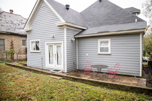 rear view of house with a yard and a patio