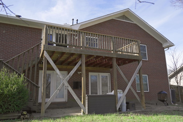 back of property featuring a patio and a wooden deck