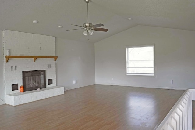 unfurnished living room featuring a fireplace, hardwood / wood-style floors, ceiling fan, and lofted ceiling