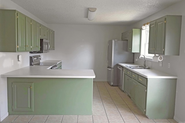 kitchen featuring sink, stainless steel appliances, kitchen peninsula, a textured ceiling, and light tile patterned floors