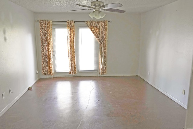 unfurnished room featuring ceiling fan, a textured ceiling, and concrete floors