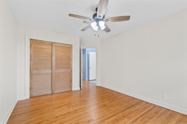 unfurnished bedroom featuring ceiling fan, a closet, and light hardwood / wood-style floors