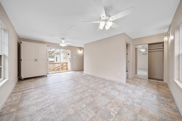 unfurnished living room with ceiling fan