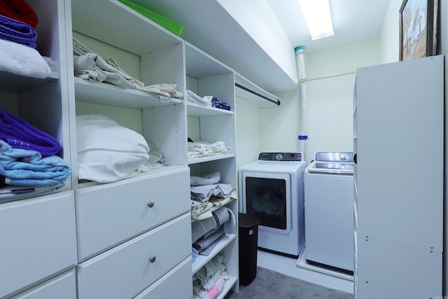 clothes washing area featuring carpet flooring and washer and dryer