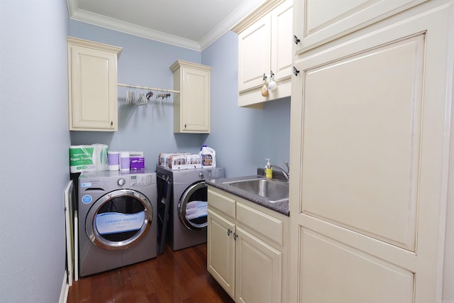 laundry area with cabinets, ornamental molding, dark wood-type flooring, sink, and separate washer and dryer