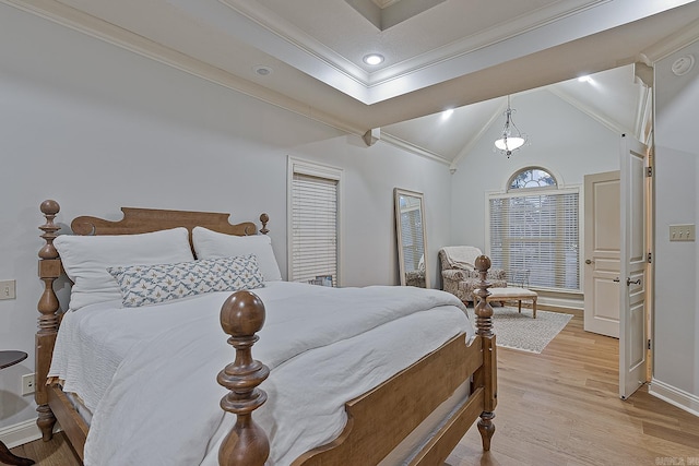 bedroom with vaulted ceiling, light hardwood / wood-style flooring, and ornamental molding