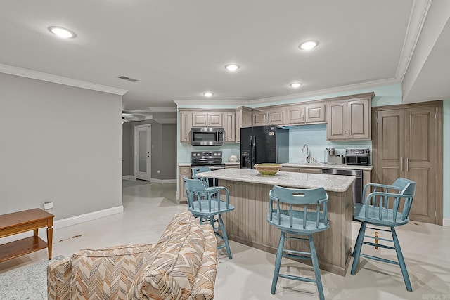 kitchen featuring sink, stainless steel appliances, crown molding, a breakfast bar, and a kitchen island