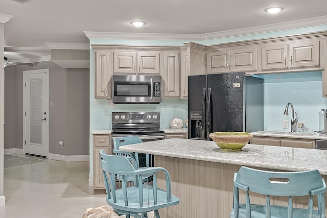 kitchen with a kitchen bar, ornamental molding, ceiling fan, sink, and black appliances