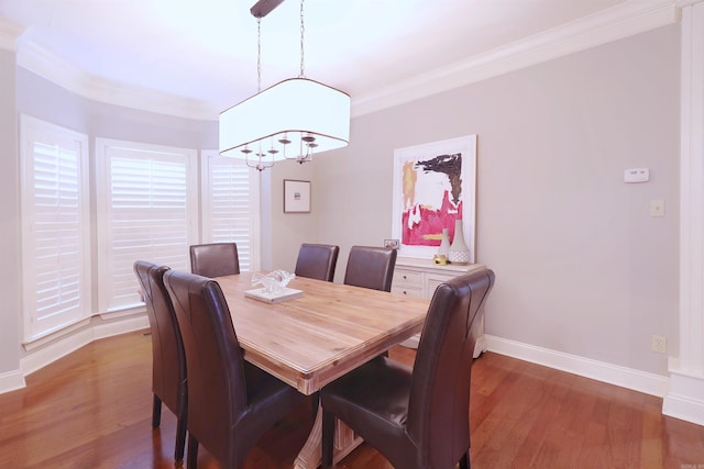 dining area featuring crown molding and dark wood-type flooring