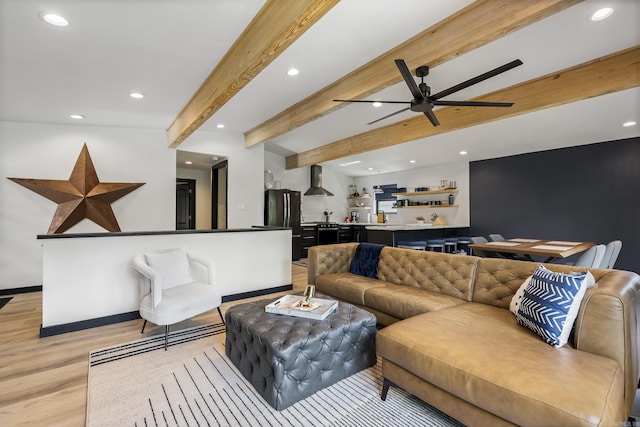 living room featuring ceiling fan, beam ceiling, and light hardwood / wood-style floors