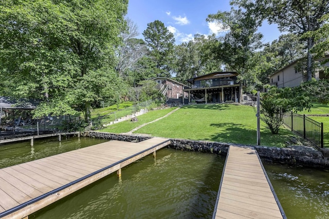 dock area featuring a yard and a water view