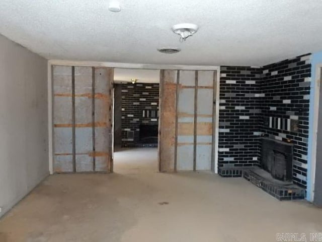 basement featuring a textured ceiling