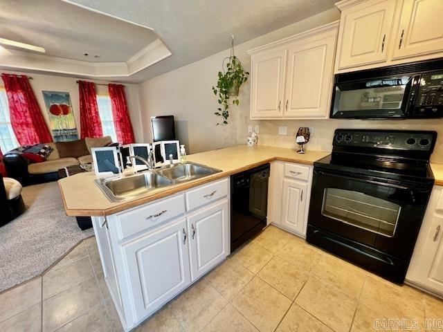 kitchen featuring black appliances, white cabinetry, kitchen peninsula, and sink