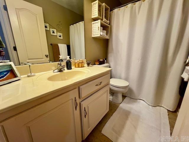 bathroom featuring tile patterned flooring, vanity, and toilet