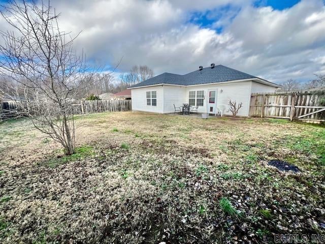 rear view of house with a lawn