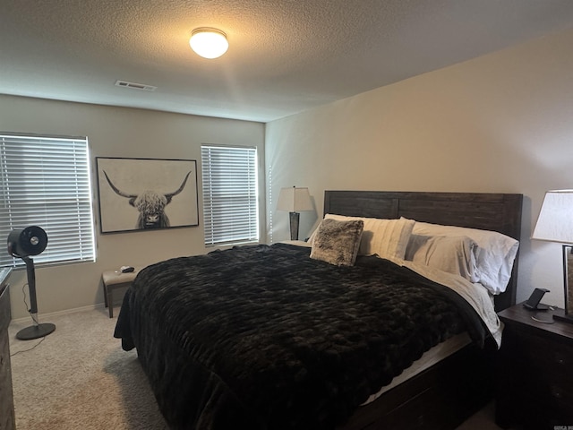 carpeted bedroom featuring a textured ceiling