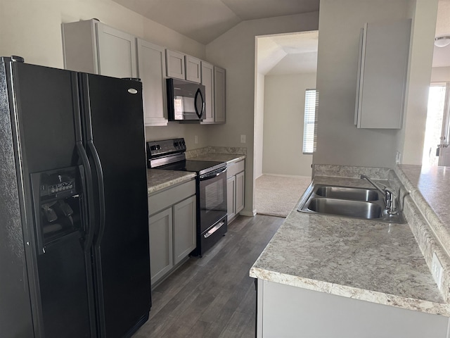 kitchen featuring dark hardwood / wood-style flooring, sink, vaulted ceiling, and black appliances