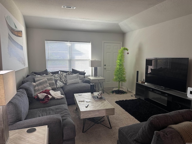 carpeted living room featuring lofted ceiling