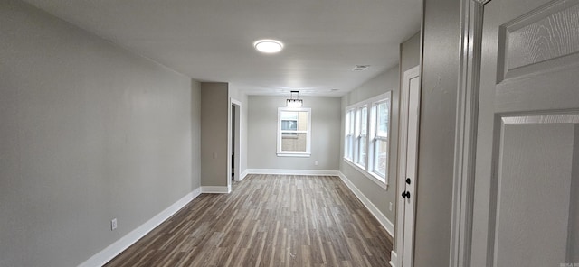 corridor featuring dark hardwood / wood-style floors