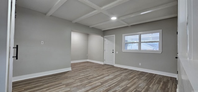 spare room featuring beamed ceiling, hardwood / wood-style floors, and coffered ceiling