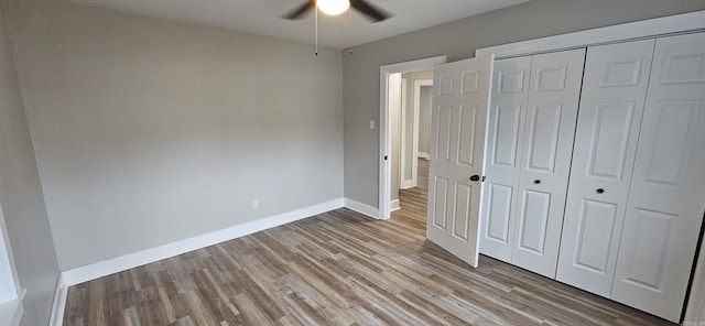 unfurnished bedroom with ceiling fan, a closet, and light hardwood / wood-style floors