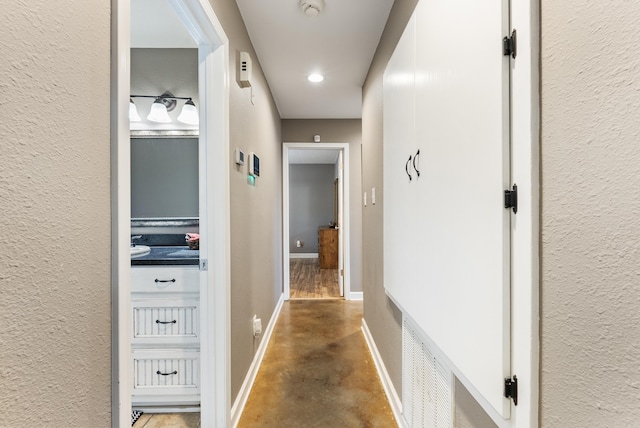 hall featuring concrete floors