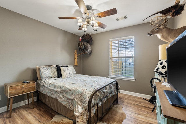 bedroom with light wood-type flooring and ceiling fan