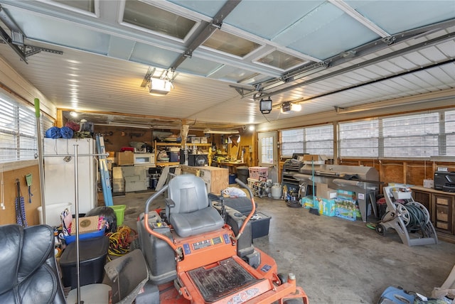 garage with a workshop area and a garage door opener