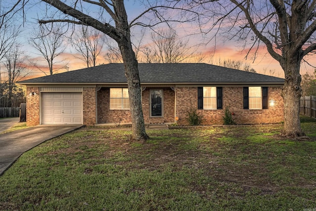 single story home featuring a yard and a garage