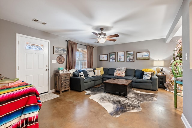 living room with ceiling fan and concrete floors