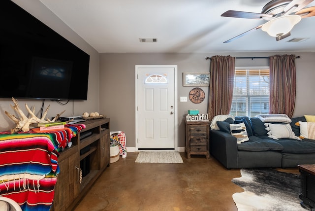 living room with ceiling fan and concrete flooring