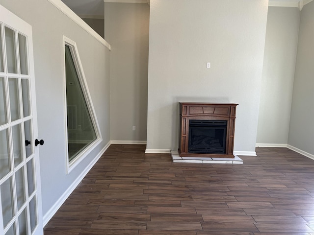 unfurnished living room with crown molding and dark hardwood / wood-style flooring