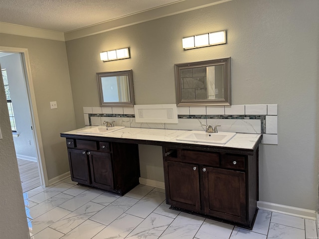 bathroom featuring a textured ceiling, vanity, tasteful backsplash, and crown molding