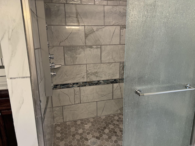 bathroom featuring a shower with door