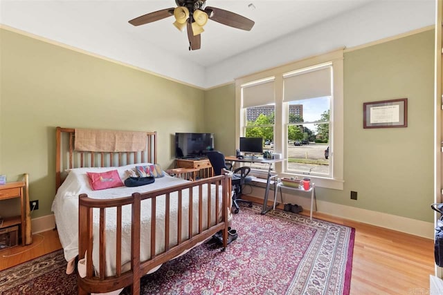 bedroom with ceiling fan and light hardwood / wood-style flooring