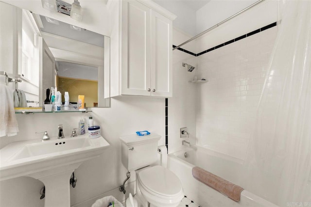 bathroom featuring shower / bathtub combination with curtain and toilet