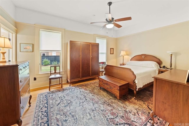 bedroom with light wood-type flooring and ceiling fan