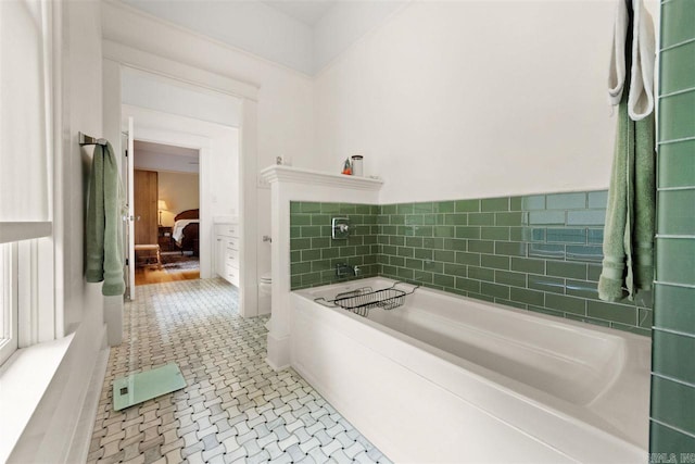 bathroom with tile patterned floors and a bathtub