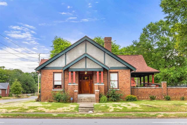 tudor home featuring a front yard