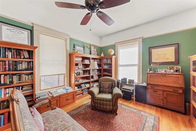 living area featuring ceiling fan, plenty of natural light, and light hardwood / wood-style floors