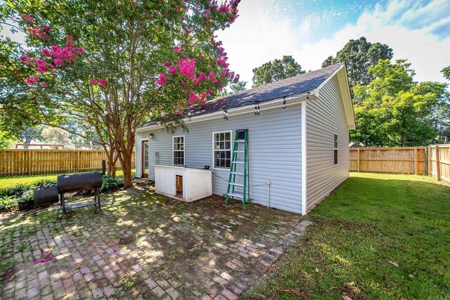 back of house with a yard and a patio area