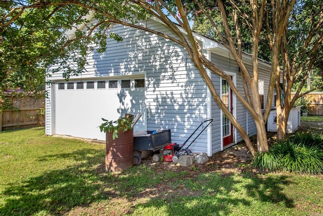 view of home's exterior featuring a lawn and an outdoor structure