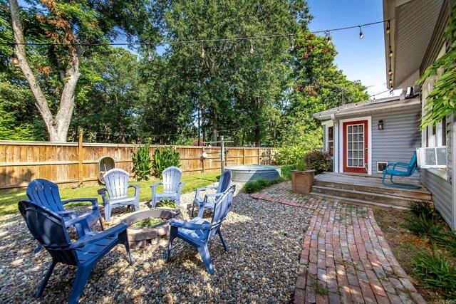 view of yard with a deck and an outdoor fire pit