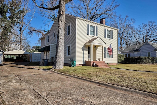 view of front of property featuring a carport and a front lawn