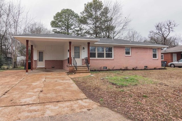 ranch-style house featuring a carport