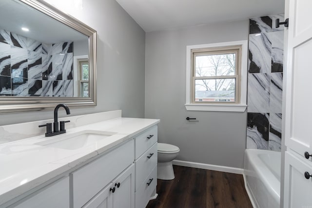 full bathroom with vanity, hardwood / wood-style flooring, toilet, and tub / shower combination