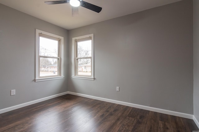 empty room with dark hardwood / wood-style flooring and ceiling fan