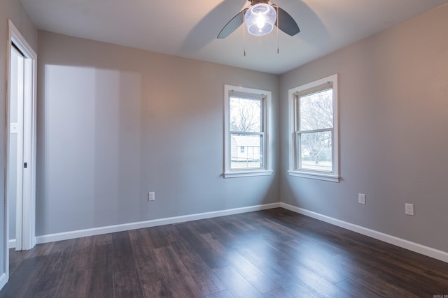 empty room featuring ceiling fan and dark hardwood / wood-style flooring