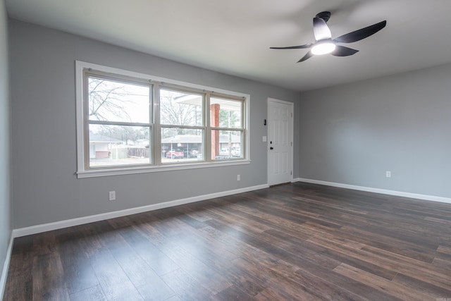 spare room featuring dark hardwood / wood-style floors and ceiling fan